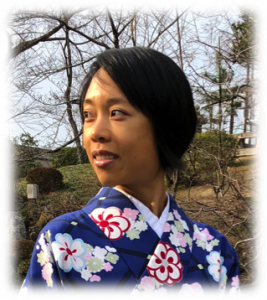 Headshot of S.L. Yang wearing a kimono with trees in the background